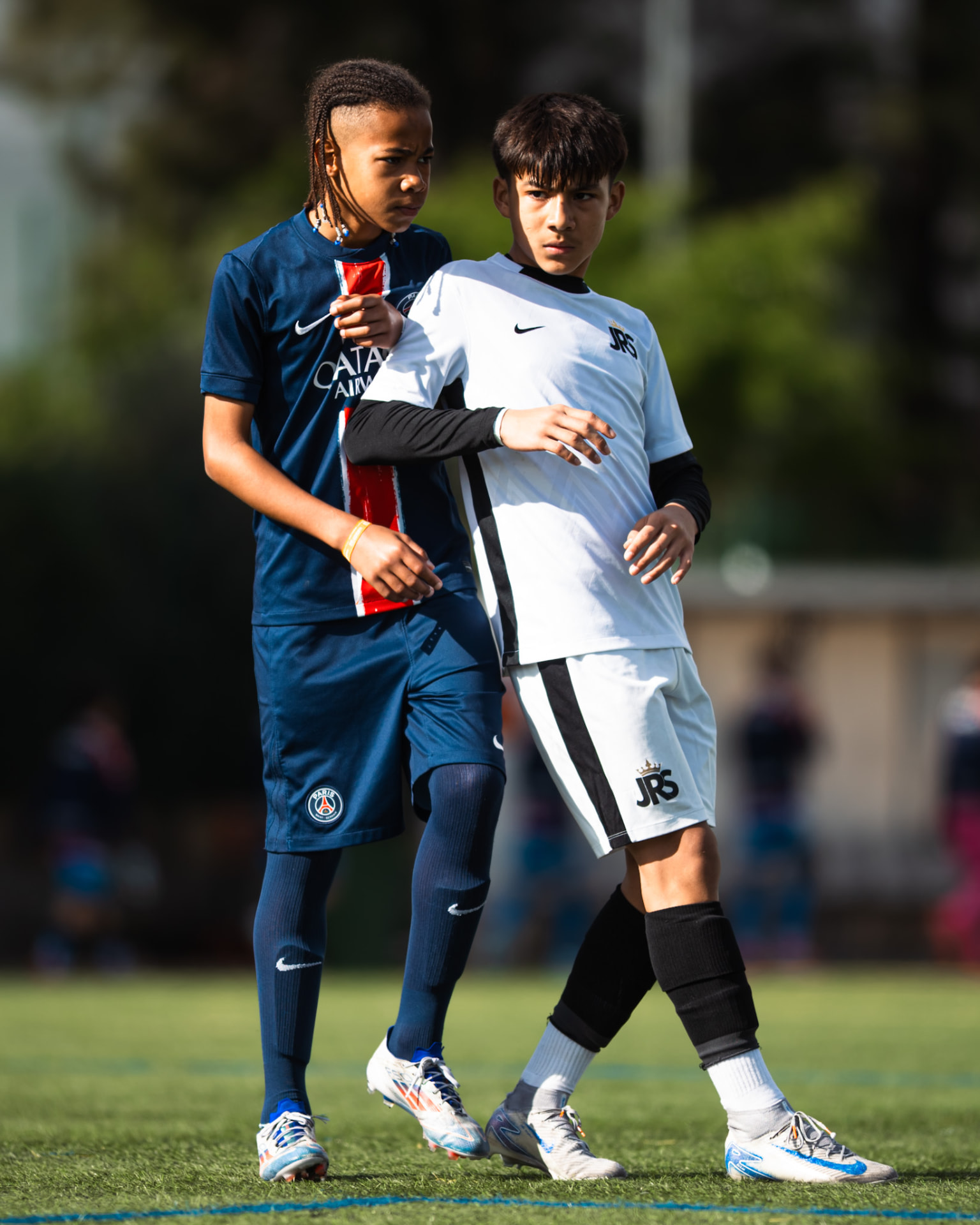 A JRS player shields the ball from a Paris Saint-Germain academy opponent at the Number One Cup in Wrocław, Poland.