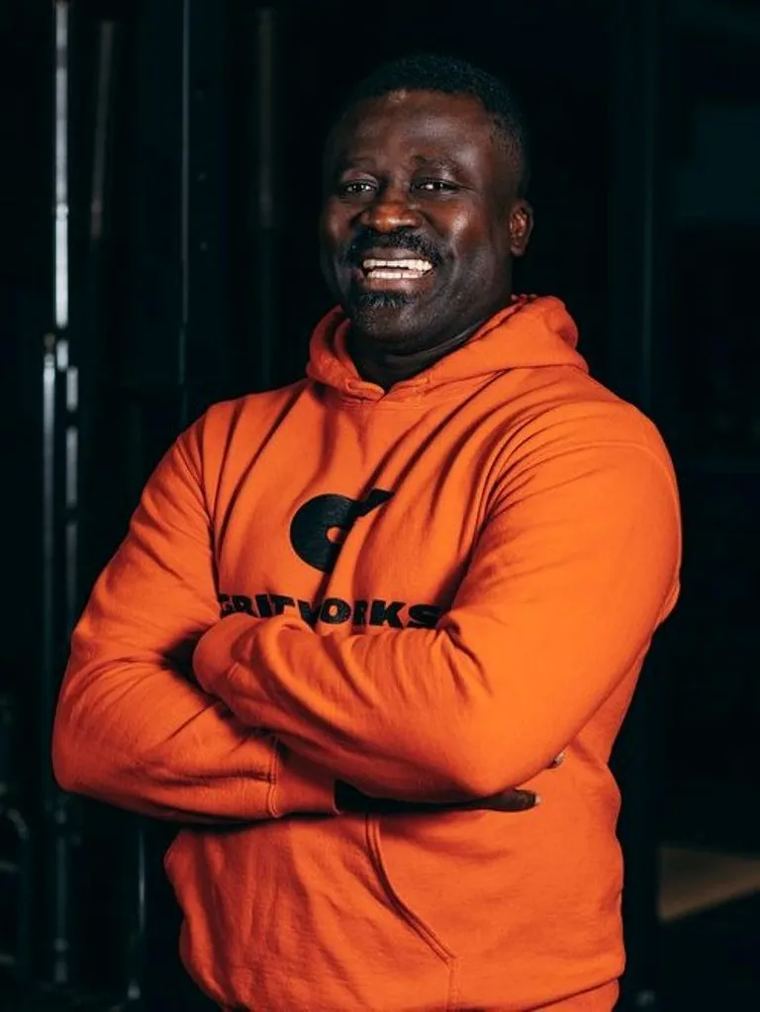 Coach portrait in an orange Gritworks hoodie