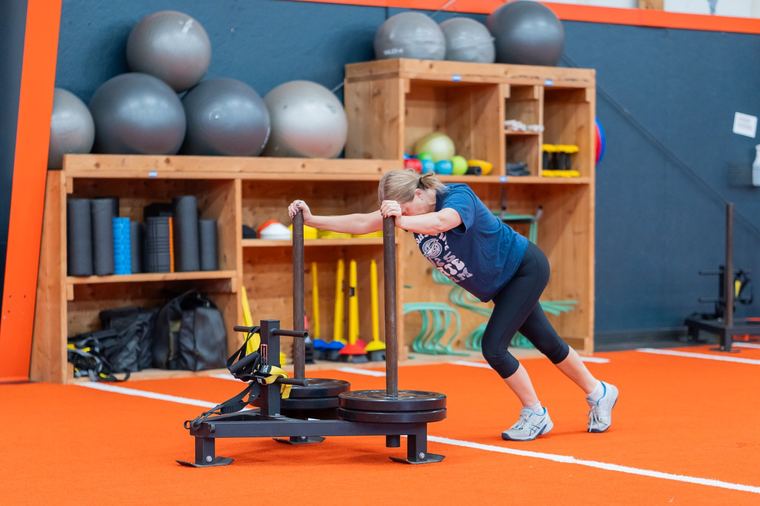 Young athlete pushing a sled