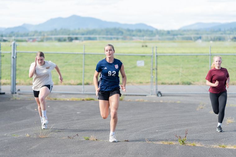 Athletes sprinting outdoors