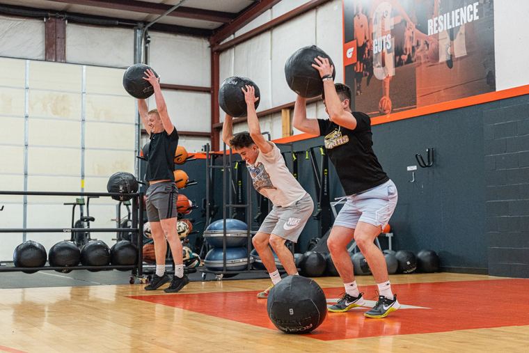 Athletes throwing medicine balls