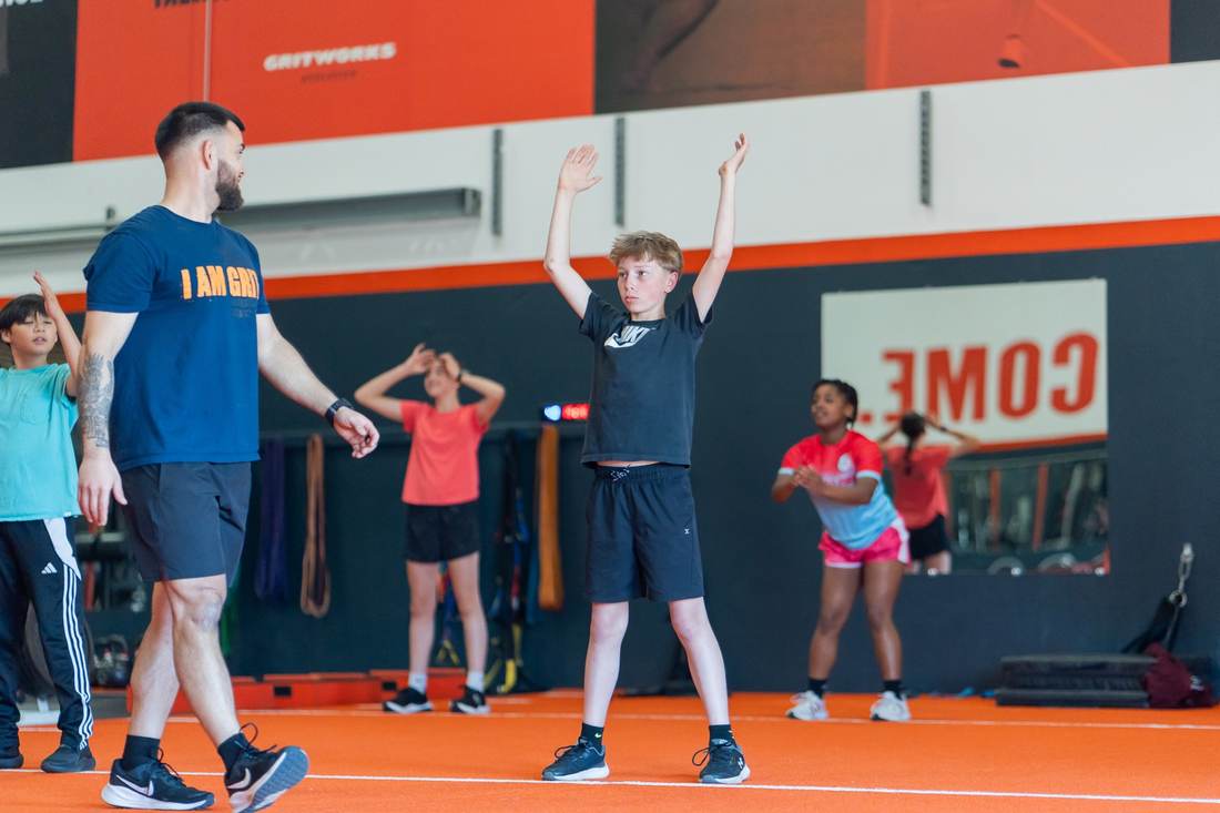 Coach leading athletes on the floor