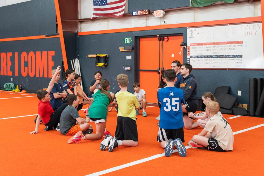 Coach talking with young athletes