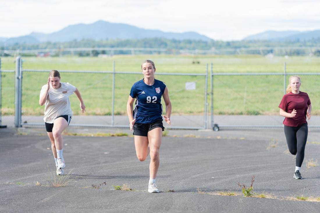 Athletes sprinting outdoors