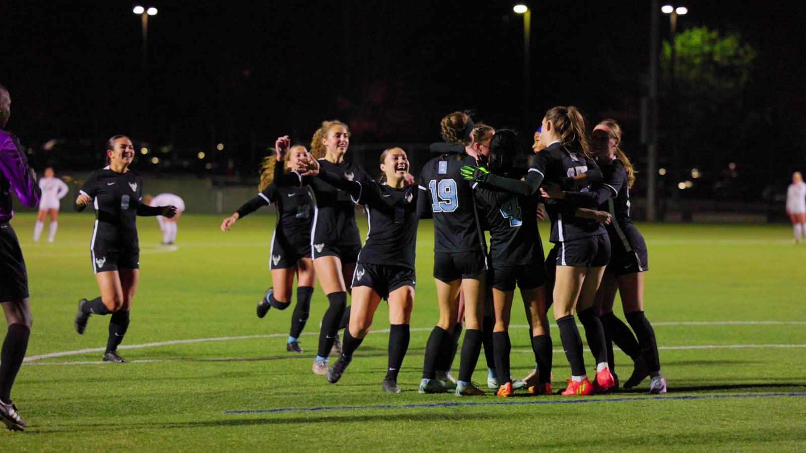 Western Washington players celebrate a goal under the lights, from Suubi Media match coverage.