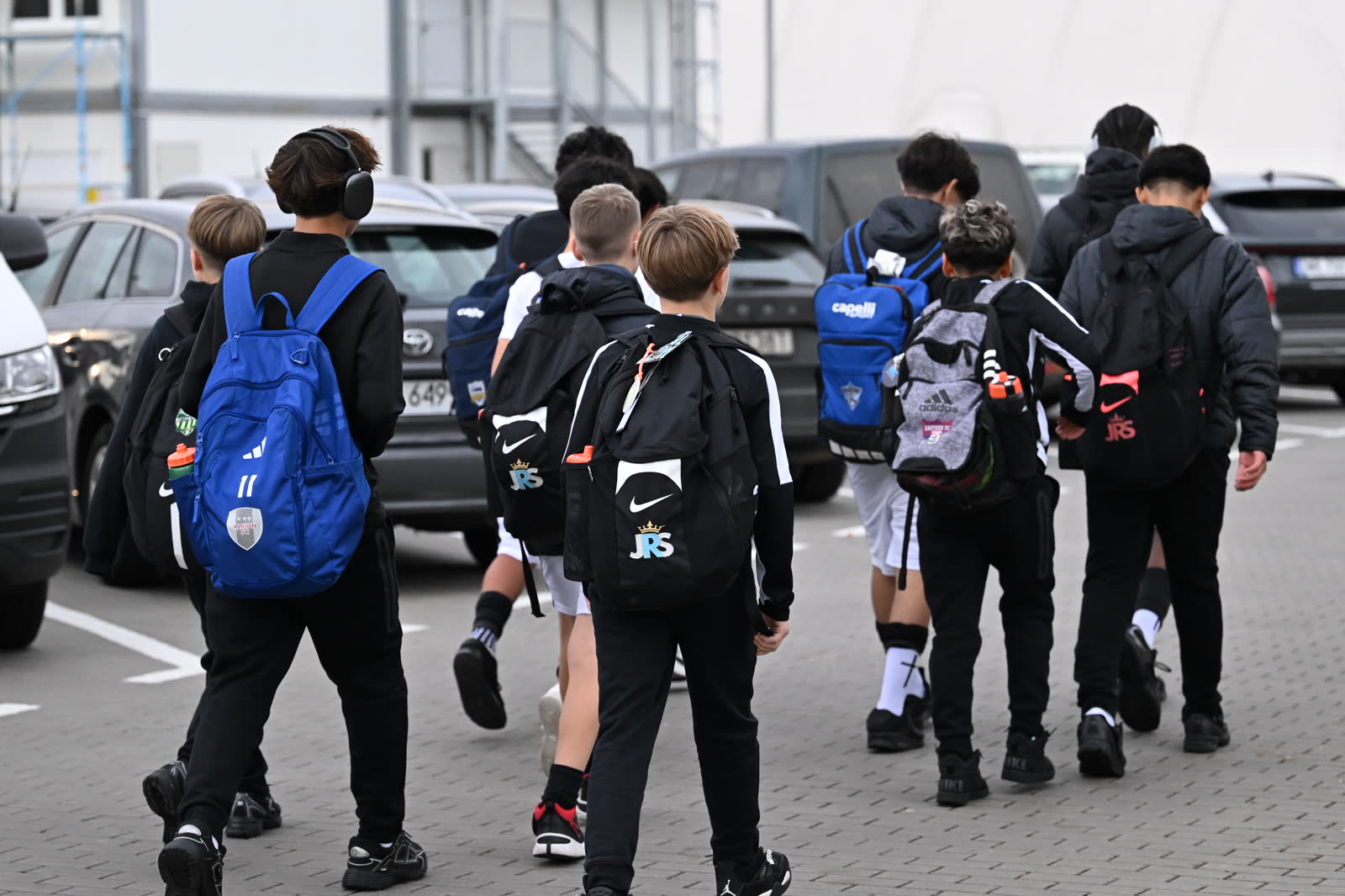 The JRS squad walks into the venue with their kit bags on tournament day in Wrocław, Poland.