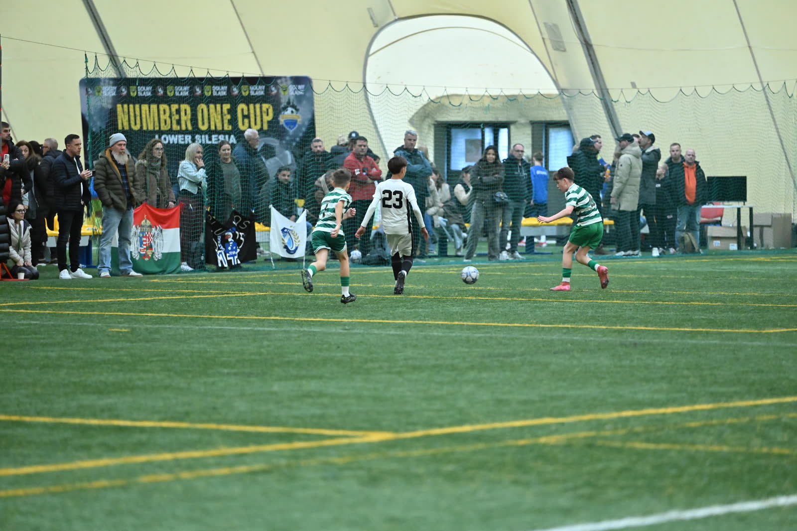 Play under the Number One Cup banners inside the covered pitch in Wrocław, Poland.