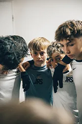 Young soccer players lean in close together