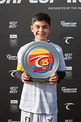A young player holds up a trophy plate in front of a tournament backdrop