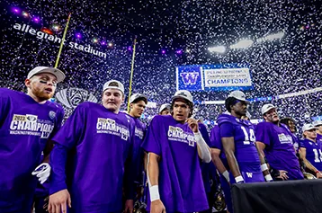 Confetti falls on players in purple champions shirts at Allegiant Stadium