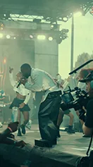 A crew member works in a hazy, green lit room