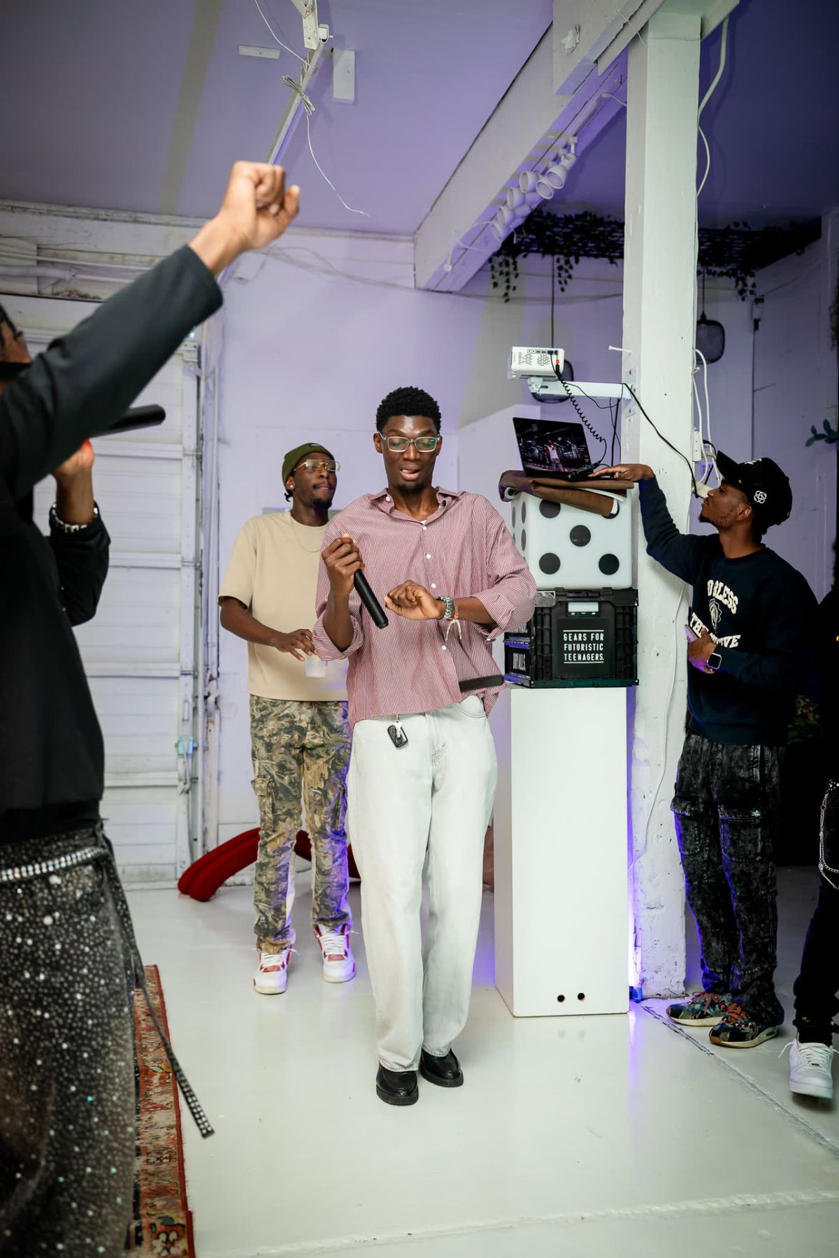 Guests raise their hands during a Seyi Buzz creative social event in Seattle, Washington.