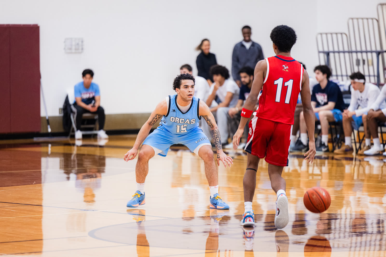 A Whatcom Community College defender sets his stance in front of the ball handler during a home game in Bellingham.