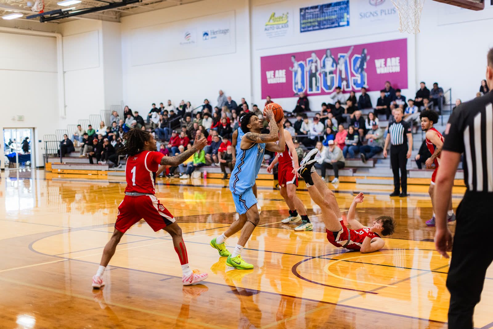 A Whatcom Community College guard drives into the paint and goes up through contact during a home game in Bellingham.
