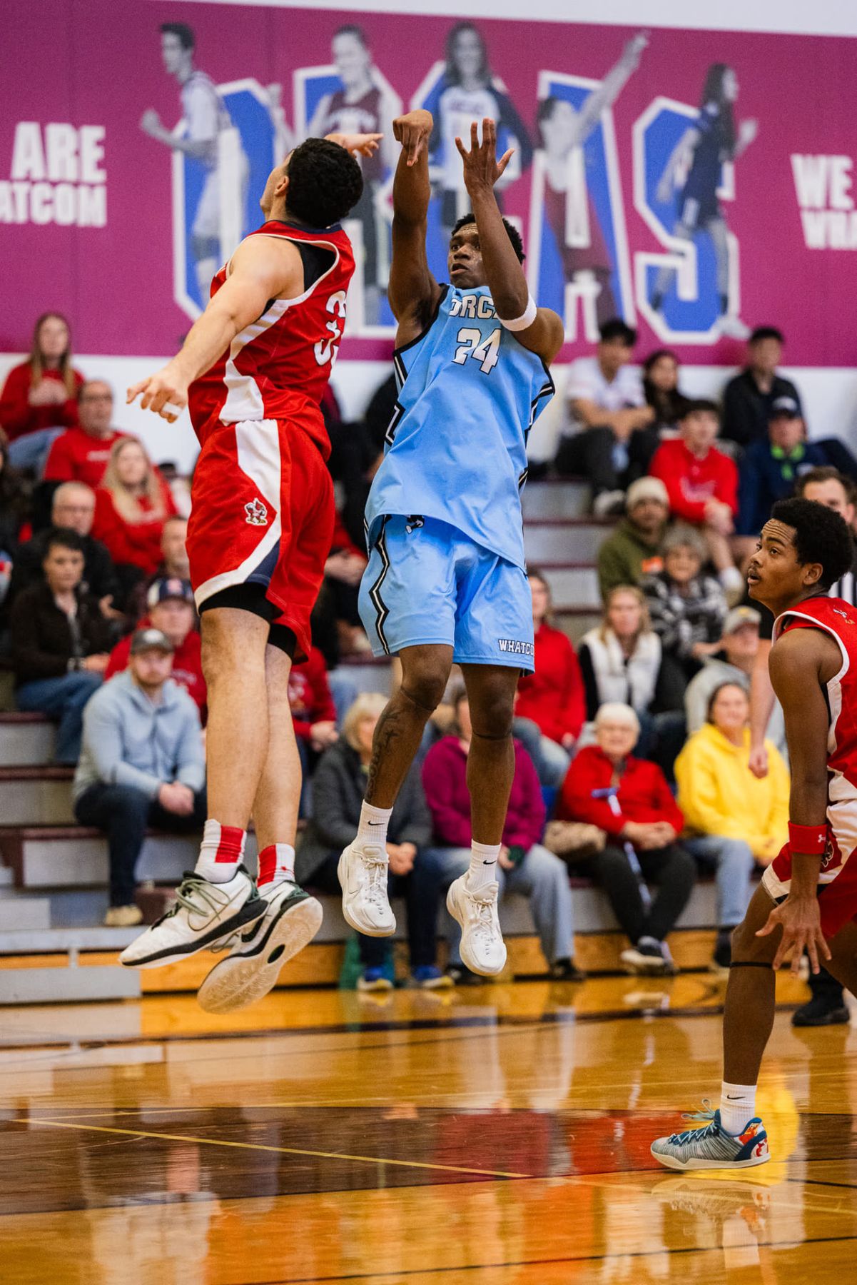 A Whatcom Community College player rises for a contested jump shot during a home game in Bellingham.