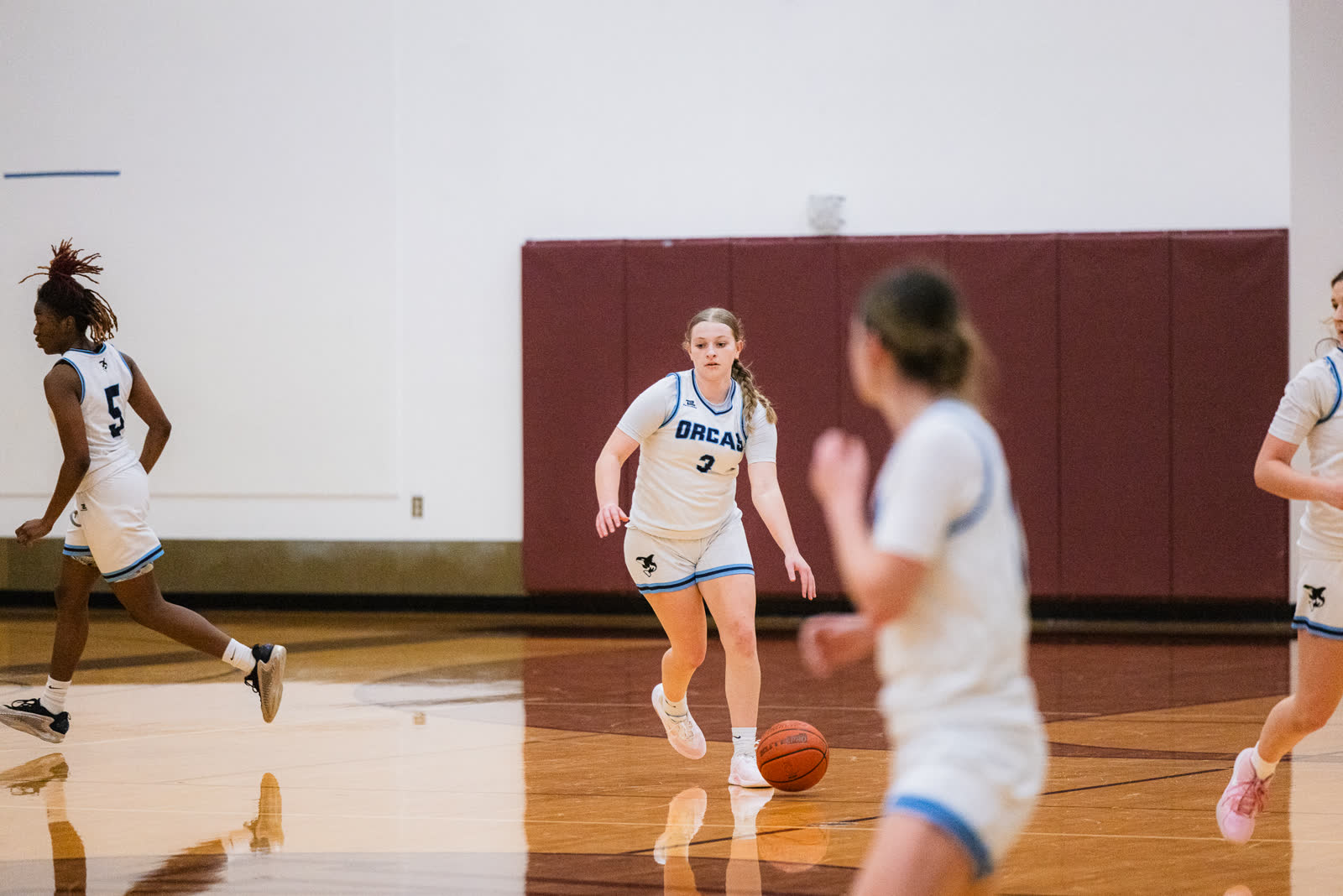A Whatcom Community College player pushes the ball up the floor on a fast break during a home game in Bellingham.