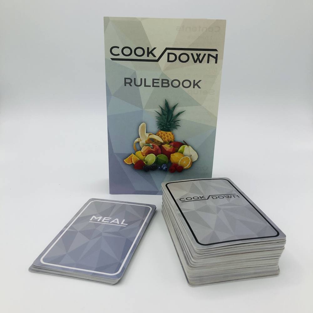 The Cookdown rulebook with the two card decks