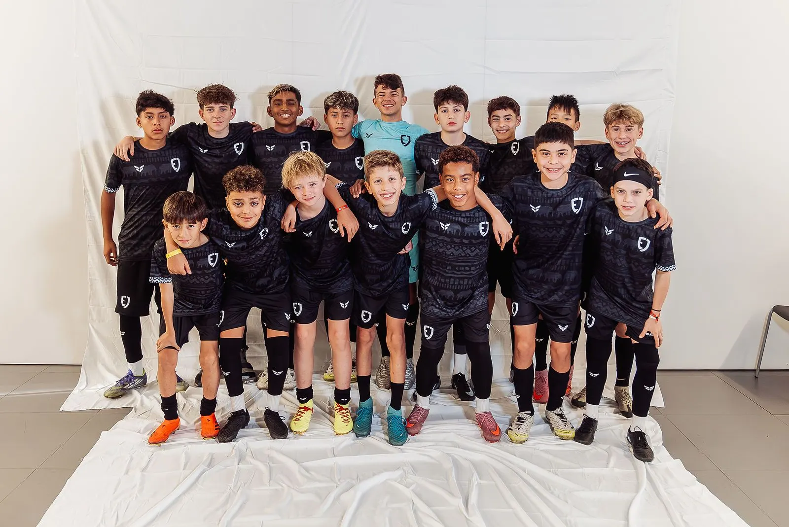 EJ Futball boys squad on a white backdrop