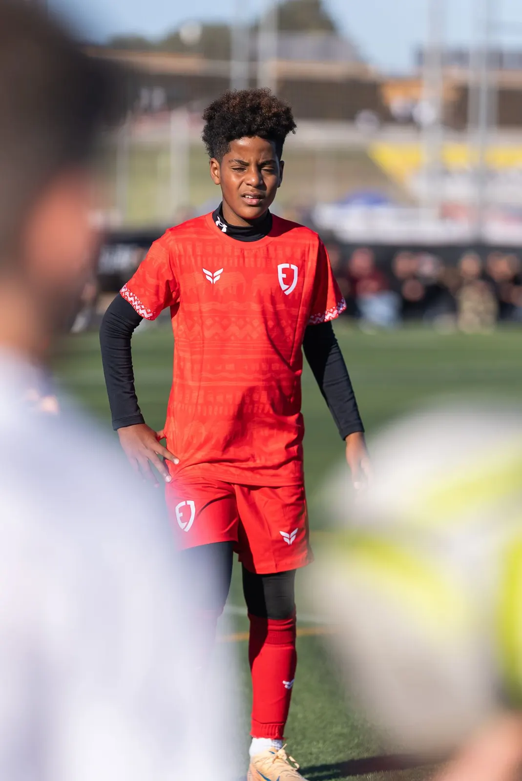 Player in red on the ball in Spain
