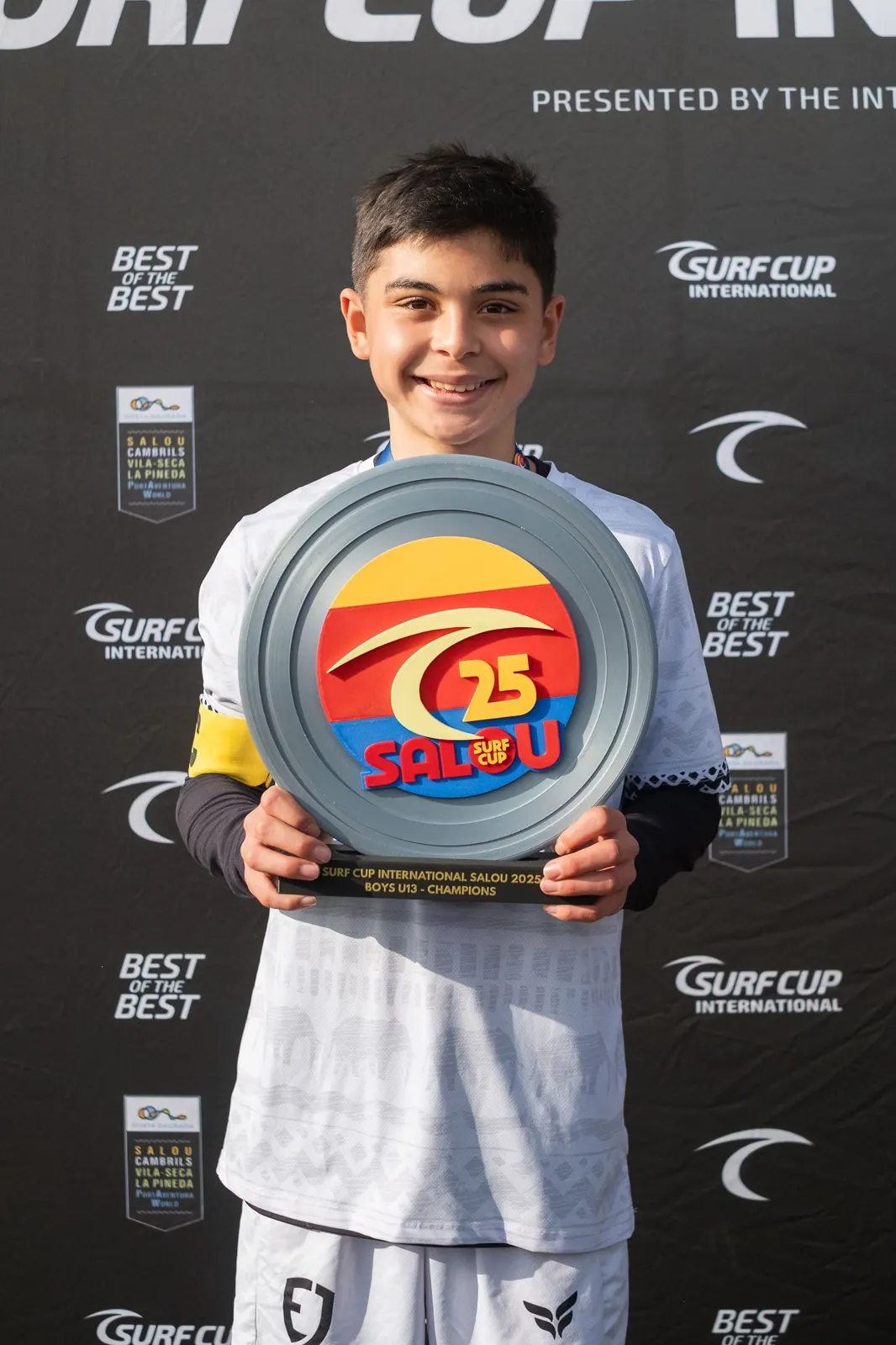 EJ Futball player holding an MVP award at Surf Cup International